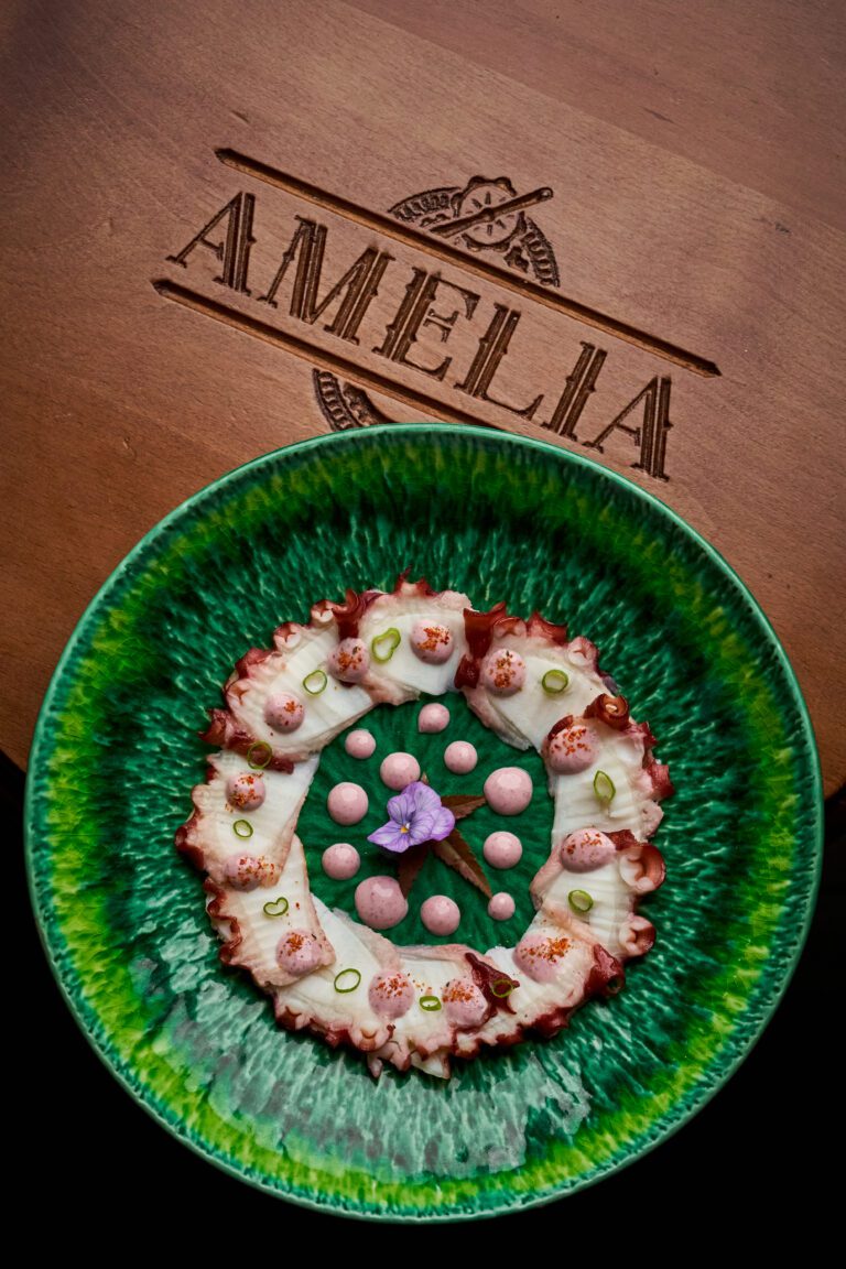 A plated dish with truffle-infused ingredients symbolizing culinary innovation at Amelia Restaurant and Lounge.