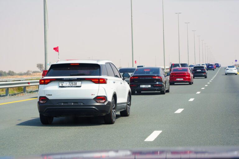 Bestune car convoy driving through scenic UAE landscape.
