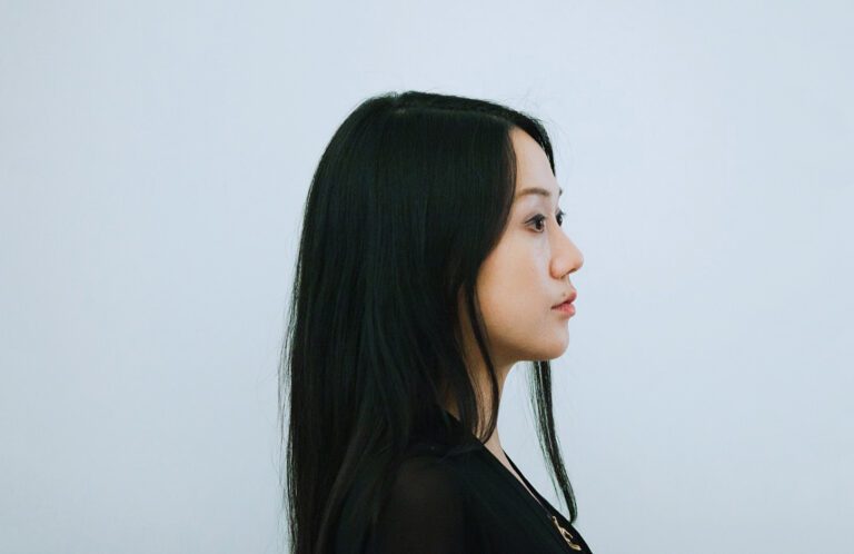 Sougwen Chung standing next to her artwork, "MEMORY (Drawing Operations Unit: Generation 2)