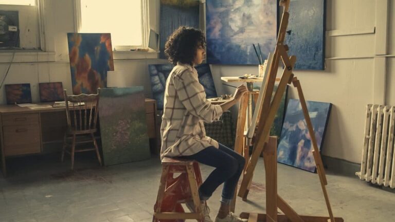 Art student painting on canvas, representing the diverse benefits of an art degree